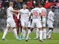 Bayer Leverkusen's Florian Wirtz, Kerem Demirbay, Piero Hincapie and Mitchel Bakker celebrate after Bayern Munich's Thomas Muller scores an own goal on March 5, 2022