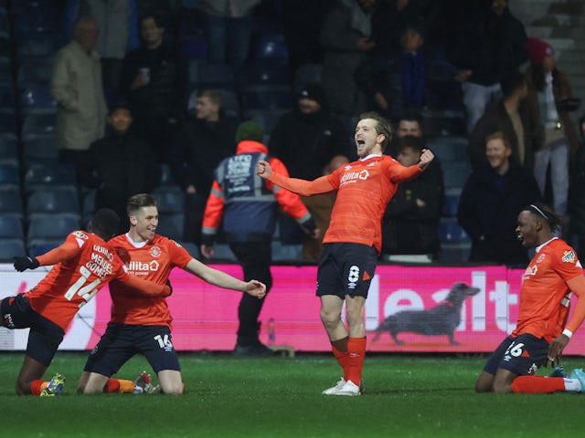 Luton Town's Reece Burke celebrates scoring their first goal with Carlos Mendes Gomes, Luke Berry and Admiral Muskwe on March 2, 2022