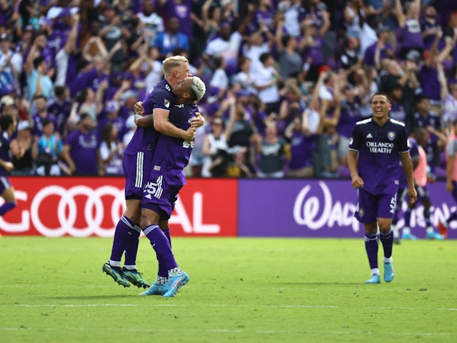 Orlando City SC defender Robin Jansson (6) and Antônio Carlos (25) celebrate as forward Benji Michel (19) (not pictured) scores a goal during the second half at Orlando City Stadium on February 27, 2022
