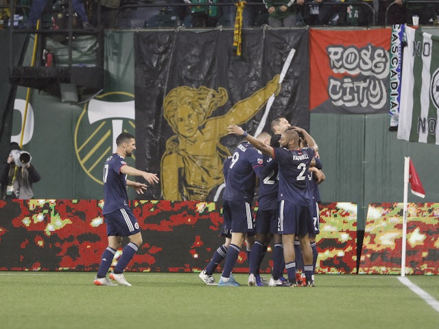 New England Revolution defender Brandon Bye (15) celebrates with teammates after scoring a goal against the Portland Timbers during the first half at Providence Park on February 26, 2022