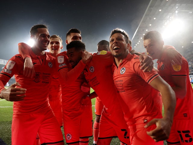 Swansea City's Cyrus Christie celebrates with his teammates after scoring the second goal on 28 February 2022