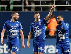 Troyes' Yoann Touzghar celebrates scoring their first goal with teammates on February 27, 2022