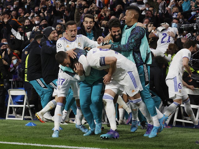 Real Madrid's Karim Benzema celebrates scoring their third goal with teammates on March 9, 2022