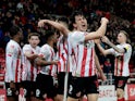 Sunderland's Luke O'Nien celebrates scoring their second goal with teammates on March 8, 2022