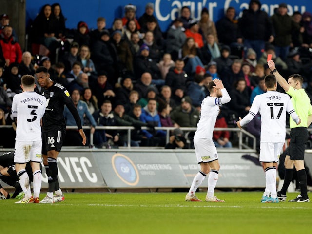 Swansea City's Ryan Manning is shown a red card by referee Jarred Gillett  on March 8, 2022
