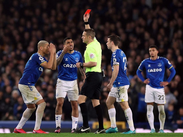 Everton's Allan is shown a red card by referee Craig Pawson as Richarlison reacts on March 17, 2022