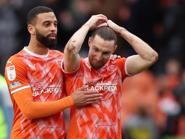 CJ Hamilton and James Husband of Blackpool celebrating after the match on 12 March 2022