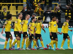 Borussia Dortmund's Marius Wolf celebrates scoring their first goal with teammates on March 13, 2022