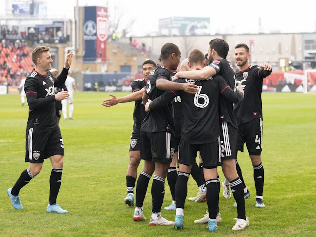 DC United midfielder Russell Canouse (6) celebrates with his teammates for a first-half goal against Toronto FC on March 19, 2022 at BMO Field
