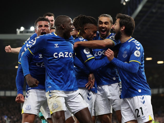 Everton's Alex Iwobi celebrates scoring their first goal with teammates on March 17, 2022