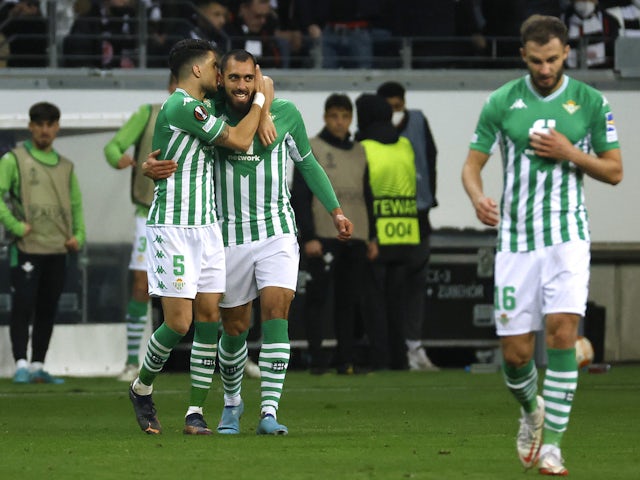 Real Betis' Borja Iglesias celebrates scoring their first goal with Marc Bartra on March 17, 2022
