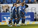 Hoffenheim's Christoph Baumgartner celebrates scoring their first goal with teammates on March 12, 2022