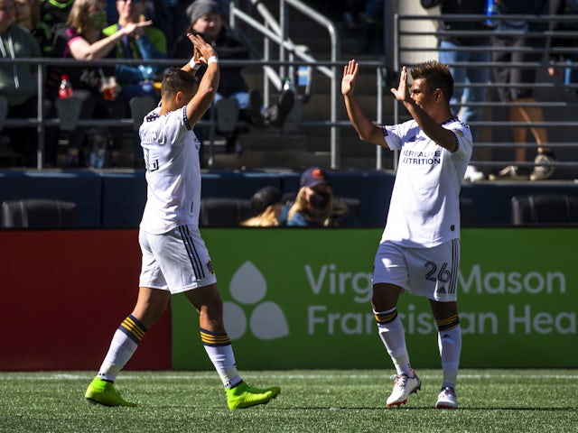 Los Angeles Galaxy forward Javier Hernandez (14) celebrates with midfielder Efrain Alvarez (26) after scoring a goal against the Seattle Sounders FC during the first half at Lumen Field on March 12, 2022