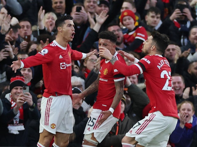 Manchester United's Cristiano Ronaldo celebrates scoring their first goal with Jadon Sancho and Alex Telles on March 12, 2022