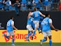 Charlotte FC forward Karol Świderski (11) celebrates with teammates after scoring a goal is in the background in the first half at Bank of America Stadium on March 19, 2022