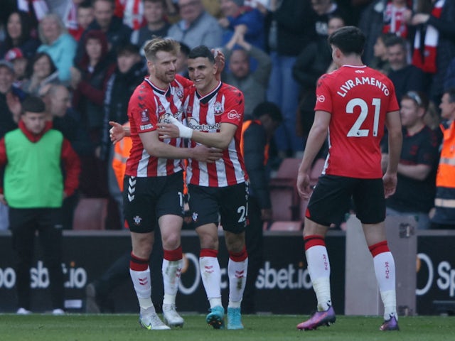 Southampton's Stuart Armstrong, Mohamed Elyounoussi and Tino Livramento celebrate their first goal, an own goal scored by Manchester City's Aymeric Laporte on March 20, 2022