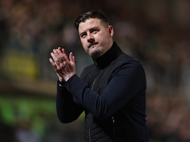 Dundee United manager Tam Courts applauds fans after the match on March 14, 2022