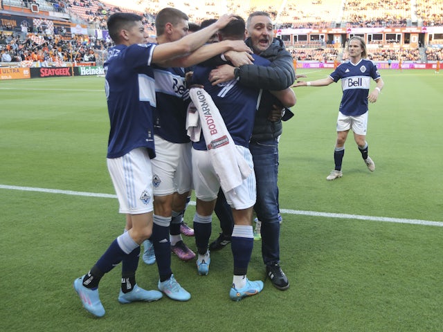Vancouver Whitecaps FC head coach Vanni Sartini and teammates celebrate FC forward Lucas Cavallini (9) goal against the Houston Dynamo FC in the first half at PNC Stadium on March 12, 2022