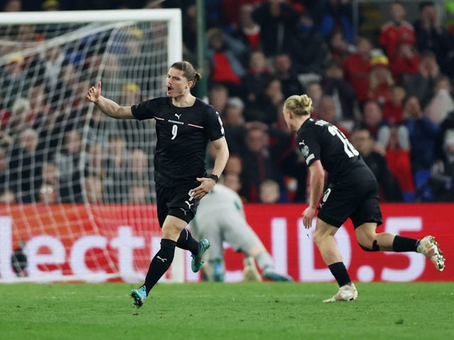 Austria's Marcel Sabitzer celebrates their first goal an own goal scored by Wales' Ben Davies on March 24, 2022