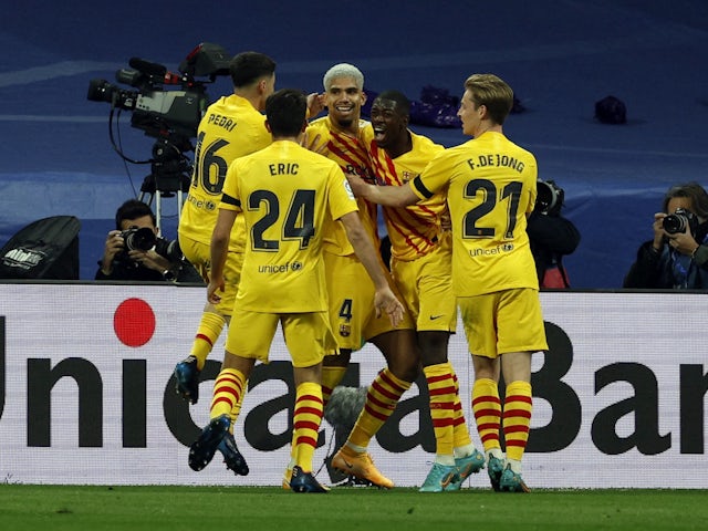 Barcelona's Ronald Araujo celebrates scoring their second goal with teammates on March 20, 2022