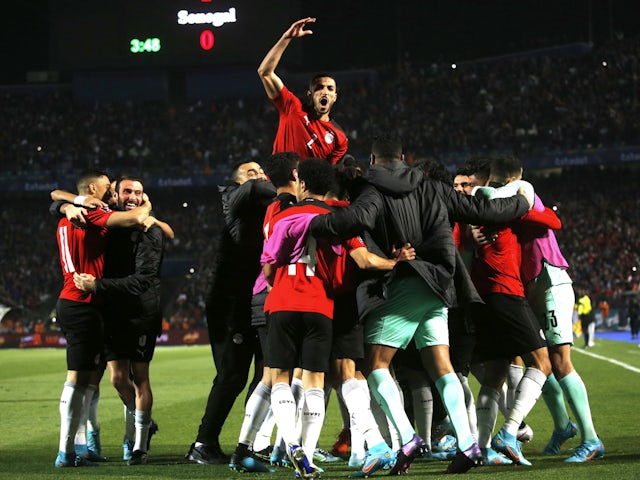 Egyptian players celebrate after Senegal's Salio Sis scored his own goal on March 25, 2022.