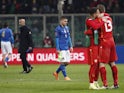 Italy's Marco Verratti looks dejected as North Macedonia players celebrate after the match on March 24, 2022