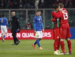 Italy's Marco Verratti looks dejected as North Macedonia players celebrate after the match on March 24, 2022