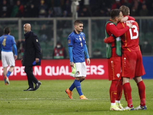 Italy's Marco Verratti looks dejected as North Macedonia's players celebrate after the match on March 24, 2022