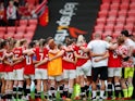 Manchester United Women's team in a huddle in 2022