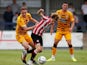 Brentford's Nathan Young-Coombes in action with Cambridge United's Adam May, on July 21, 2021