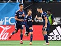 New England Revolution midfielder Carles Gil (10) reacts with midfielders Brandon Bye (15) and Sebastian Lletget (17) after making a penalty kick in the second half at Bank of America Stadium on March 20, 2022
