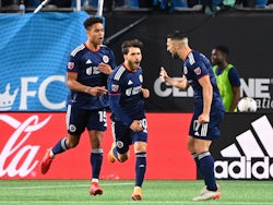 New England Revolution midfielder Carles Gil (10) reacts with midfielders Brandon Bye (15) and Sebastian Lletget (17) after making a penalty kick in the second half at Bank of America Stadium on March 20, 2022