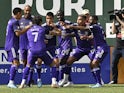Orlando City midfielder Junior Urso (11) celebrates with teammates after scoring a goal in the second half against the Portland Timbers at Providence Park on March 27, 2022
