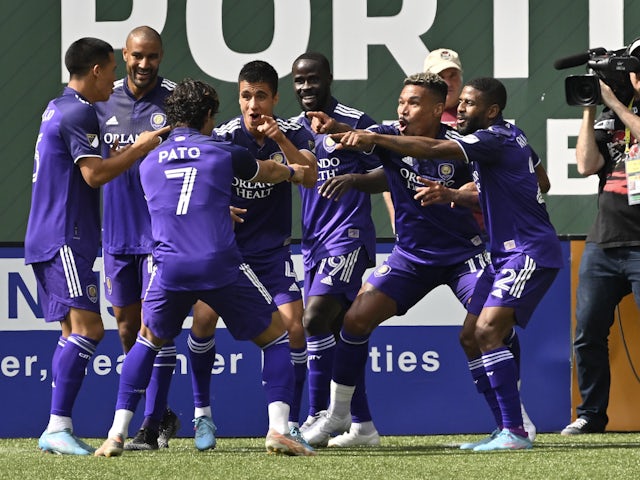 Orlando City midfielder Junior Urso (11) celebrates with teammates after scoring a goal in the second half against the Portland Timbers at Providence Park on March 27, 2022