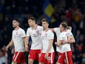 Poland's Krzysztof Piatek celebrates scoring their first goal with teammates on March 24, 2022