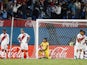 Peru's Carlos Zambrano and teammates look dejected after Uruguay's Giorgian de Arrascaeta scored their first goal on March 24, 2022