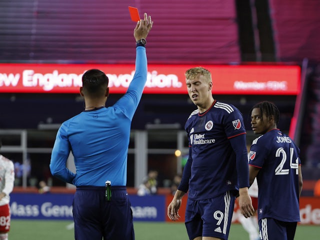 New England Revolution forward Adam Buksa (9) is given a red card by referee Victor Rivas during the second half against the New York Red Bulls at Gillette Stadium on April 3, 2022