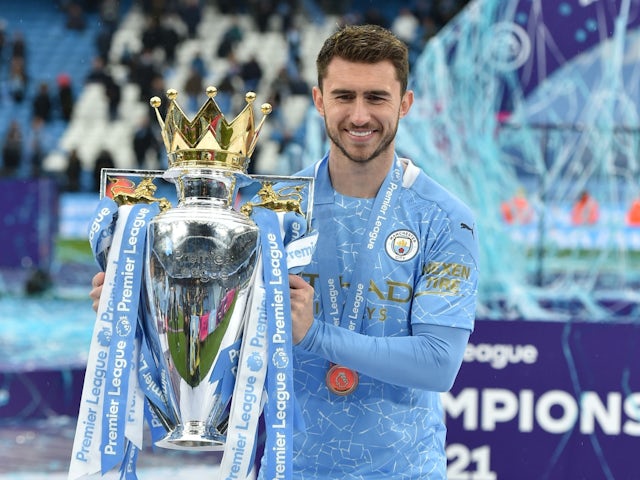 Manchester City's Aymeric Laporte poses with the Premier League trophy on May 23, 2021 