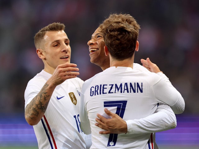 France's Kylian Mbappe celebrates scoring their first goal with teammates Antoine Griezmann and Lucas Digne on March 29, 2022