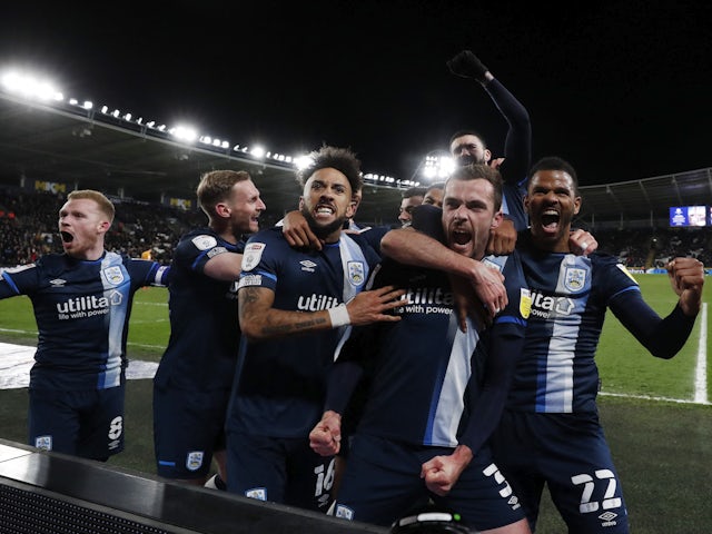 Huddersfield Town's Harry Toffolo celebrates scoring their first goal with teammates on April 1, 2022