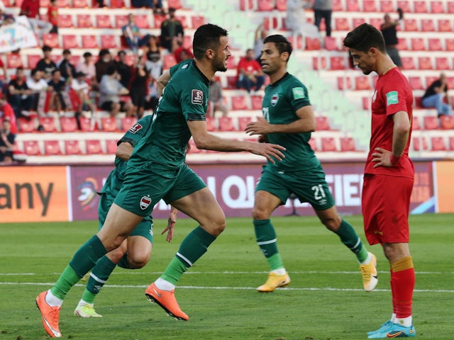 Iraq's Ayman Hussein celebrates scoring their first goal on March 29, 2022