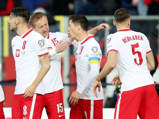 Poland's Robert Lewandowski celebrates scoring their first goal with Kamil Glik on March 29, 2022