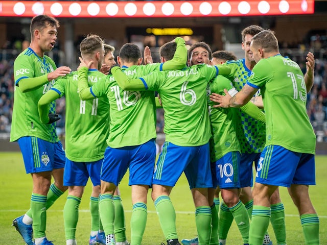 Teammates congratulate Seattle Sounders midfielder Joao Paulo (6) on scoring in the first half against Minnesota United at Allianz Field on April 2, 2022