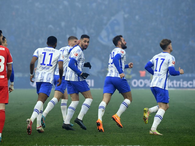 Hertha Berlin players celebrate after 1. FC Union Berlin's Timo Baumgartl scores an own goal and Hertha BSC first goal on April 9, 2022