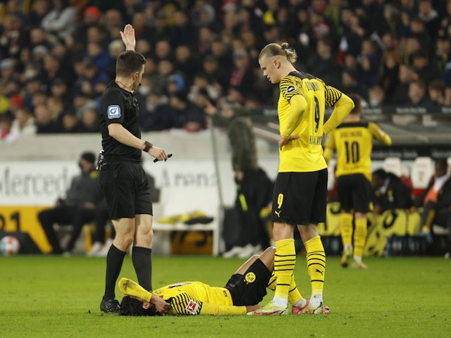 Borussia Dortmund's Mahmoud Dahoud reacts after sustaining an injury as Erling Braut Haaland looks on on April 8, 2022