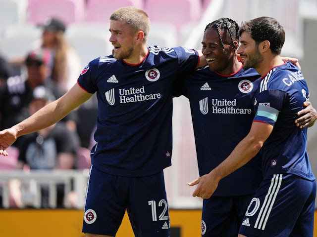 New England Revolution forward Justin Rennicks (12) celebrates with forward Justin Rennicks (center) and midfielder Carles Gil (right) after scoring a goal against Inter Miami CF during the first half at DRV PNK Stadium on April 9, 2022