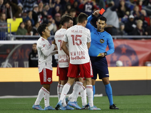 Referee Victor Rivas gives a red card to New York Red Bulls midfielder Frankie Amaya (8) (left) during the second half against the New England Revolution at Gillette Stadium on April 3, 2022