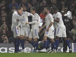 Real Madrid's Karim Benzema celebrates scoring their first goal with teammates on April 6, 2022
