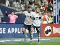 Vancouver Whitecaps midfielder Ryan Raposo (27) celebrates his goal against Sporting Kansas City goalkeeper Tim Melia (29) (not pictured) with forward Lucas Cavallini (9) during the second half at BC Place on April 3, 2022