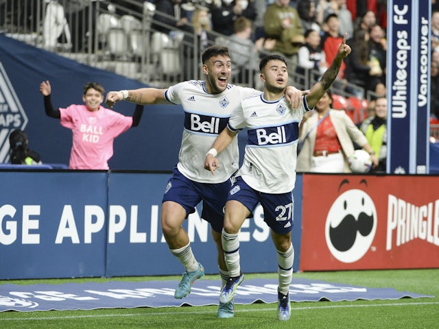 Vancouver Whitecaps midfielder Ryan Raposo (27) celebrates his goal against Sporting Kansas City goalkeeper Tim Melia (29) (not pictured) with forward Lucas Cavallini (9) during the second half at BC Place on April 3, 2022